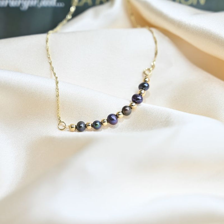 A 14 Carat Gold Chain With Black Pearl Beads Combined With 14 Carat Gold Beads