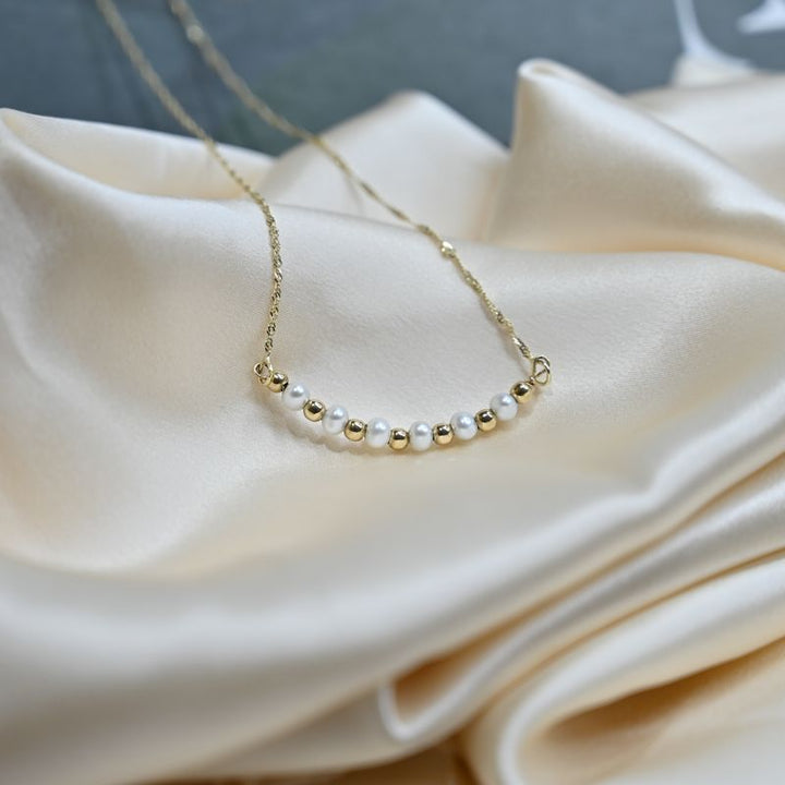 A 14 Carat Gold Chain With White Pearl Beads Combined With 14 Carat Gold Beads