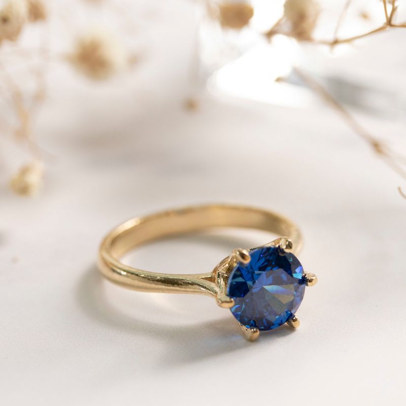 gold plated closed ring with dark blue cz 8mm facet