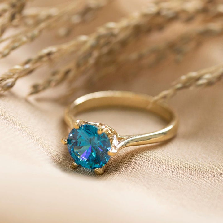 gold plated closed ring with blue cz 8mm facet