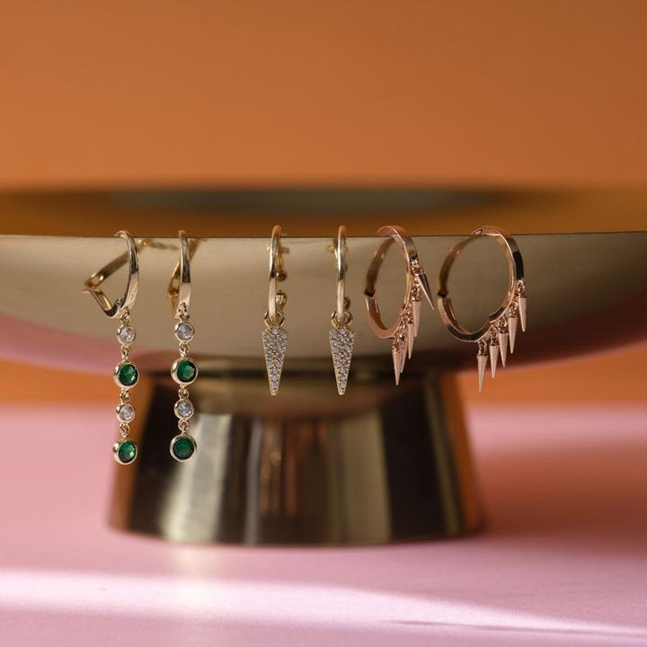 Yellow gold dangling earring with green and white zircons