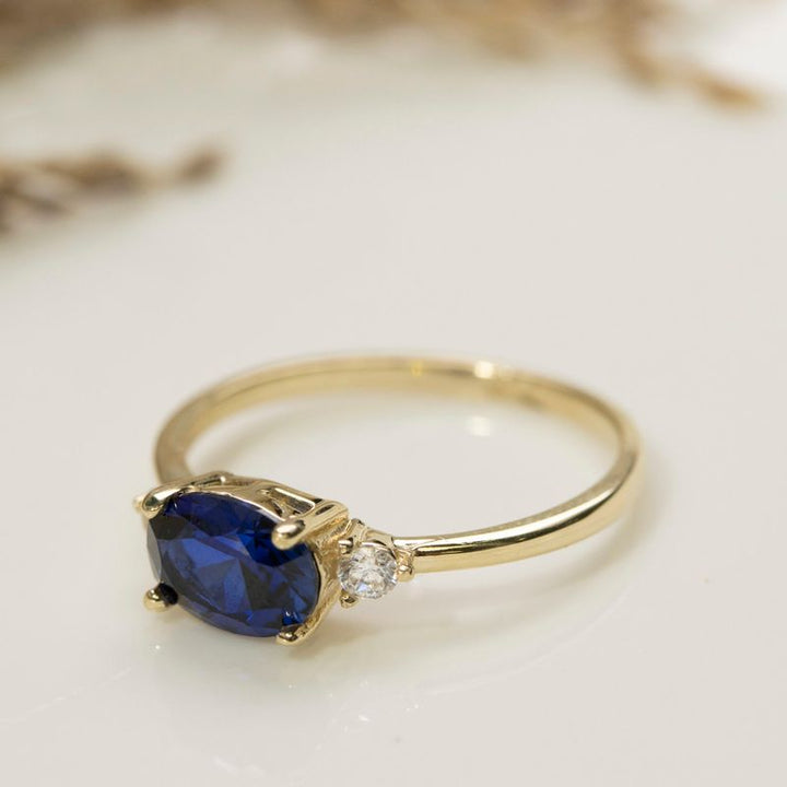 Latted Gold Ring Blue Dark 6x8 and 2 White Zircons