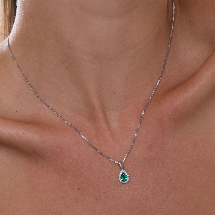 White gold drop necklace with white zircons and a green zircon in the center