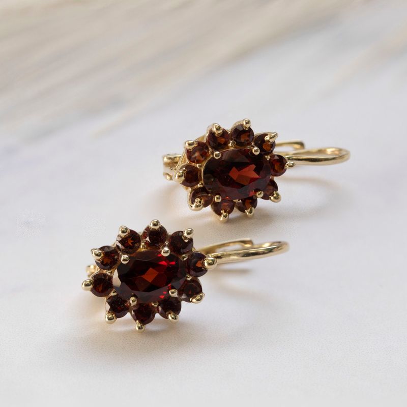 dangling Lucia earrings yellow gold inlaid with garnet stones