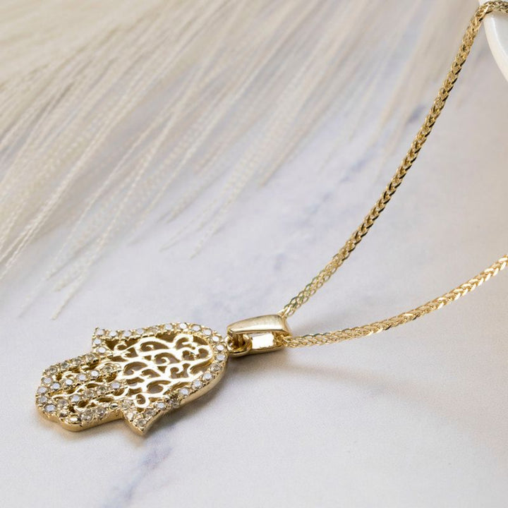 Hamsa pendant yellow gold with decorations and small white zircons