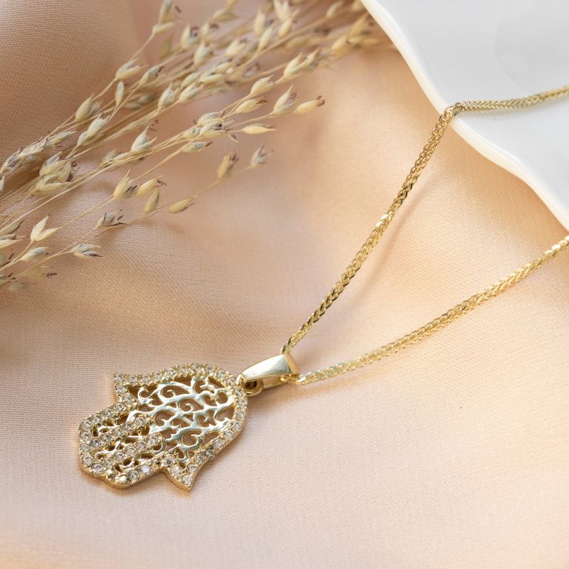 Hamsa pendant yellow gold with decorations and small white zircons