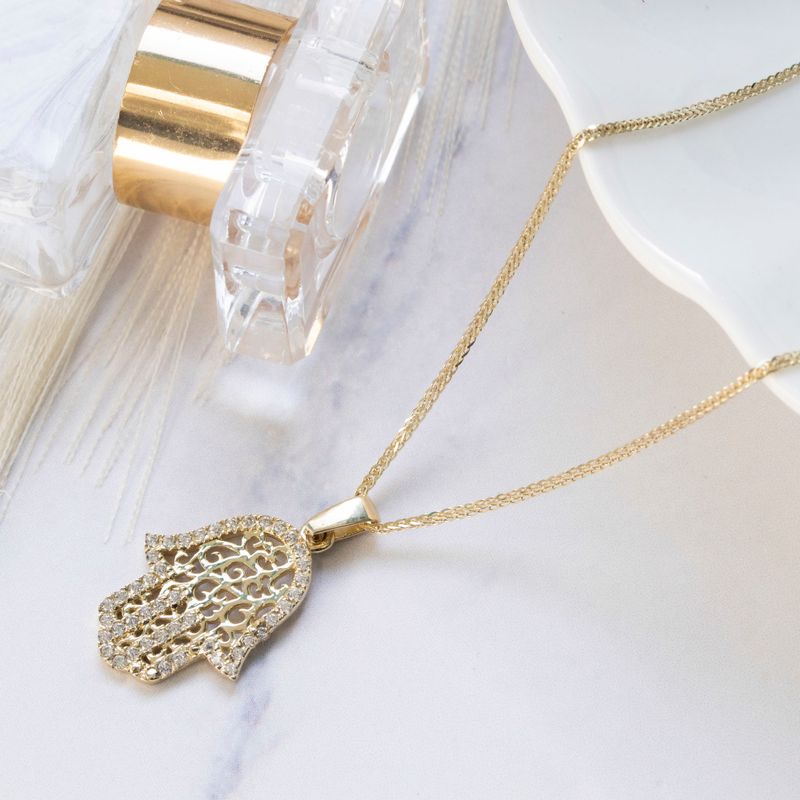 Hamsa pendant yellow gold with decorations and small white zircons