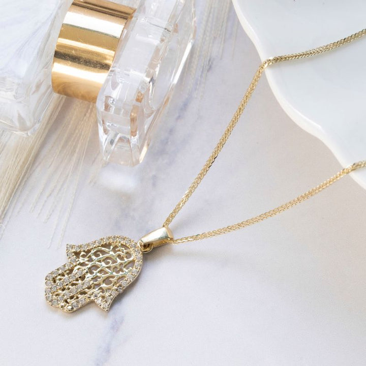 Hamsa pendant yellow gold with decorations and small white zircons