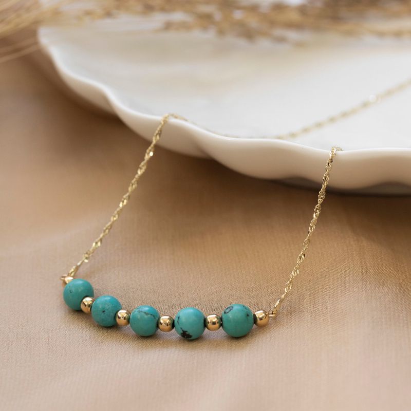 Pendant with 5 large turquoise beads combined with small gold beads