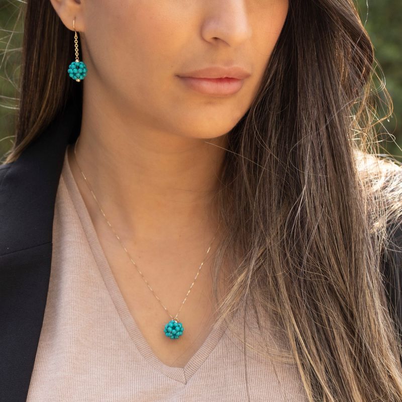 Ball-shaped turquoise bead pendant with gold hanger