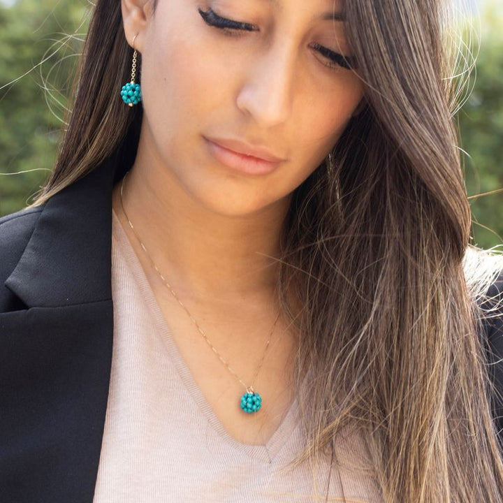 Ball-shaped turquoise bead pendant with gold hanger