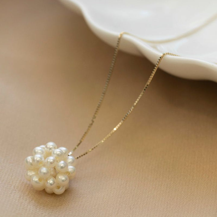 Ball shaped pearl bead pendant with gold hanger
