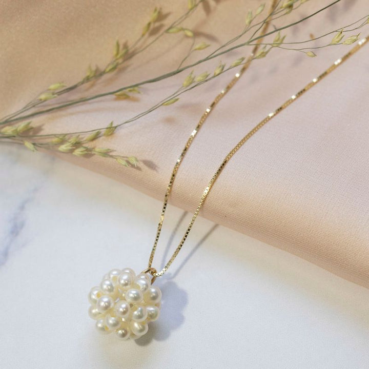 Ball shaped pearl bead pendant with gold hanger