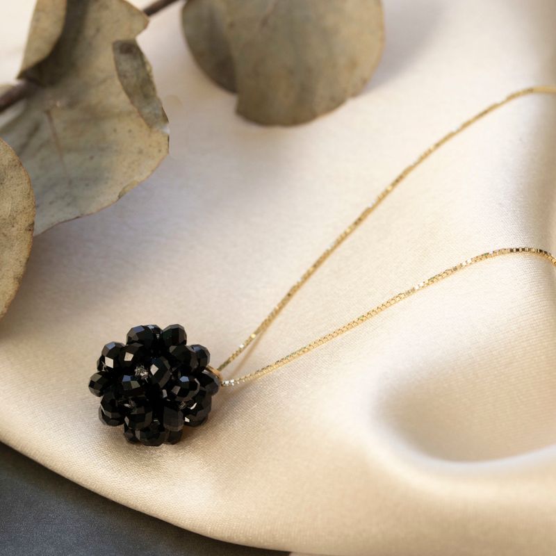 Ball-shaped black bead pendant with gold hanger